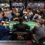 image of people playing poker. foreground shows 9 men playing poker