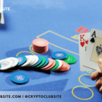 Image of a hand holding aces and casino chips on a table